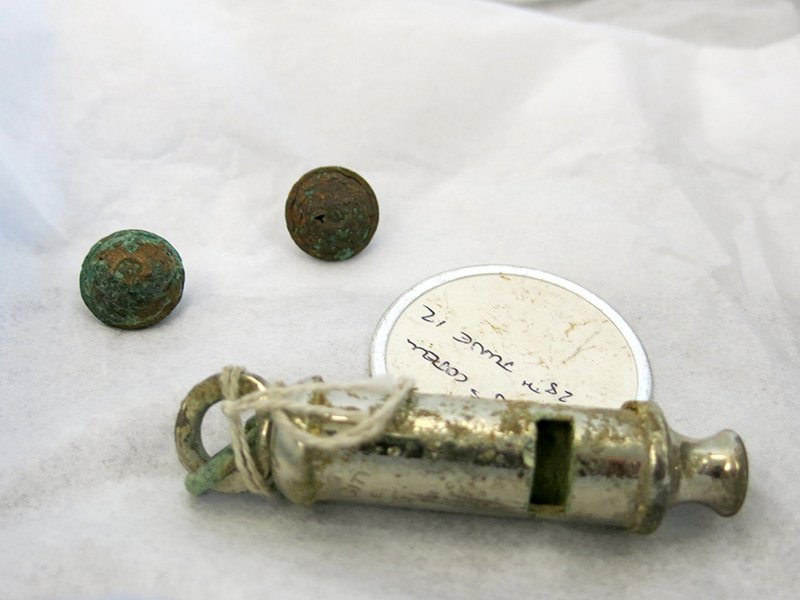 Some of the artefacts now on display at the museum: two regimental buttons and a whistle