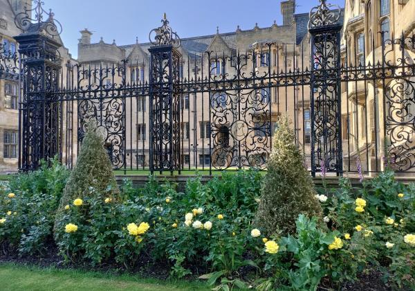 Merton College buildings, with railings and roses in the foreground