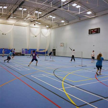 Badminton courts with games in action