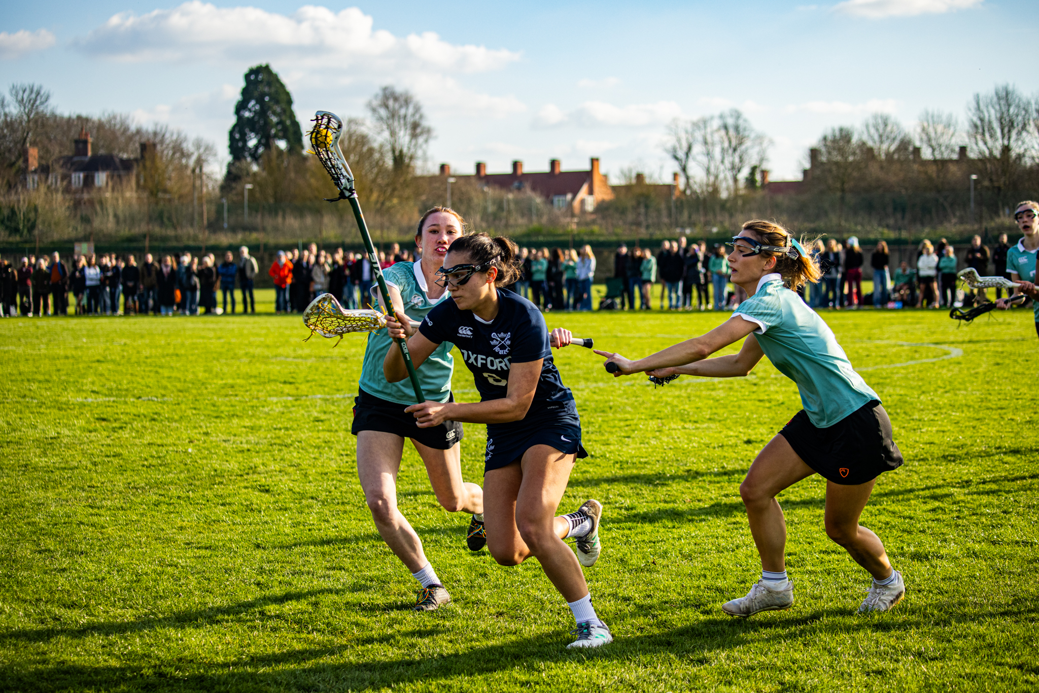 Merton DPhil student Miranda Bate (center) in the 109th annual Varsity Lacrosse Match against Cambridge.