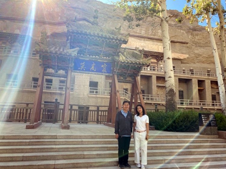 Mr Lü Ai and Rachel in front of the entrance to the Mogao Grottoes
