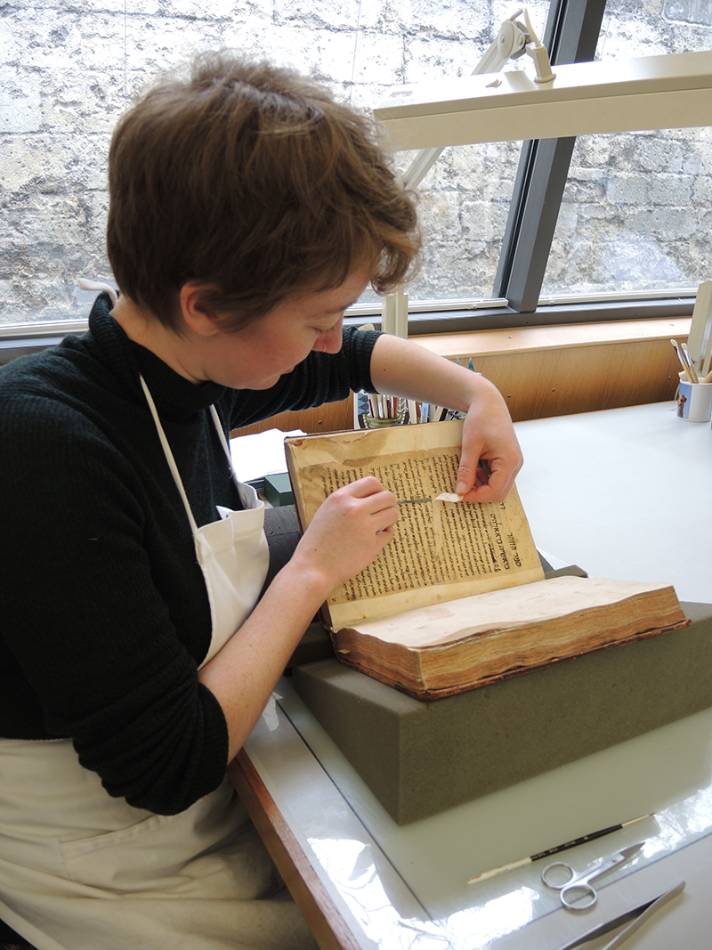 Conservator Nikki Tomkins repairs the Merton Zohar - Photo © Oxford Conservation Consortium