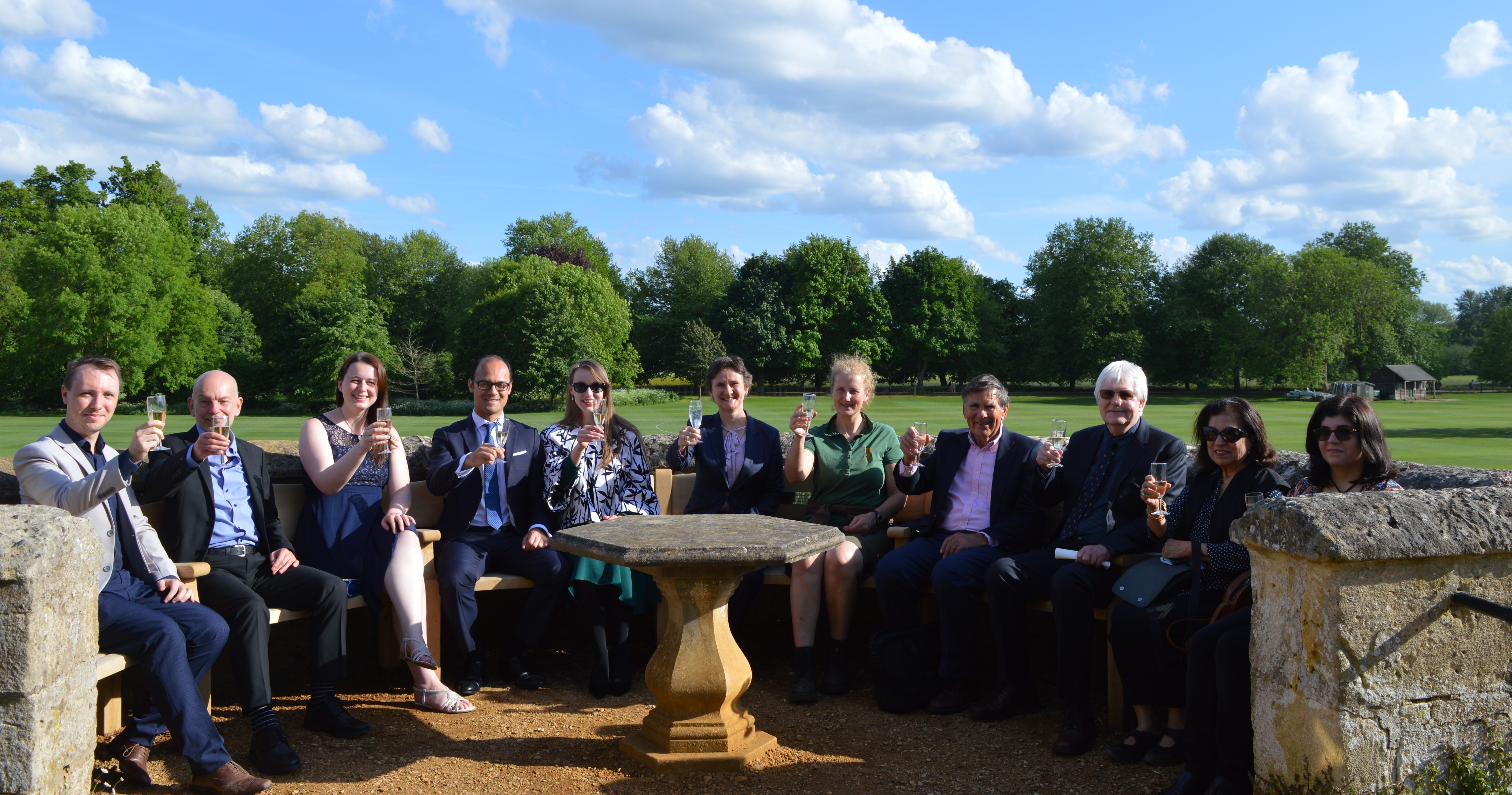 The unveiling of the new Bastion Bench, 19 May 2022. Seated are the donors, the Warden and the Head Gardener