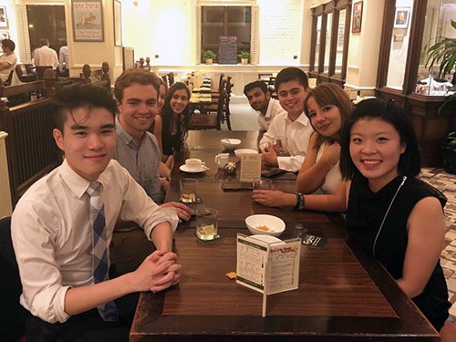 A photo inside the FCC. Left, front to back: Leo Wong (Merton College); Ross McDonald (Merton College); Stephanie Bruce-Smith (Merton College; Gerry Grimstone Grant Recipient); Riya Bhatt (Merton College; Gerry Grimstone Grant Recipient). Right, front to back: Leanne Yau (Somerville College); Isadora Janssen (Merton College; Gerry Grimstone Grant Recipient); Adrian Burbie (Merton College; Gerry Grimstone Grant Recipient); Ayaz Mohamedali (St Anne’s College)