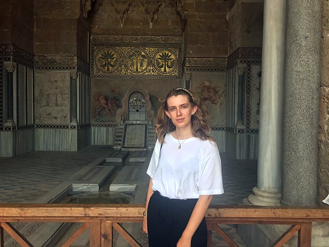 Ellen Sharman in front of a Norman mosaic and fountain at Zisa Castle in Palermo