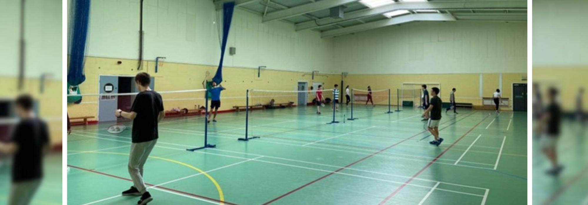 Badminton players practising on the courts