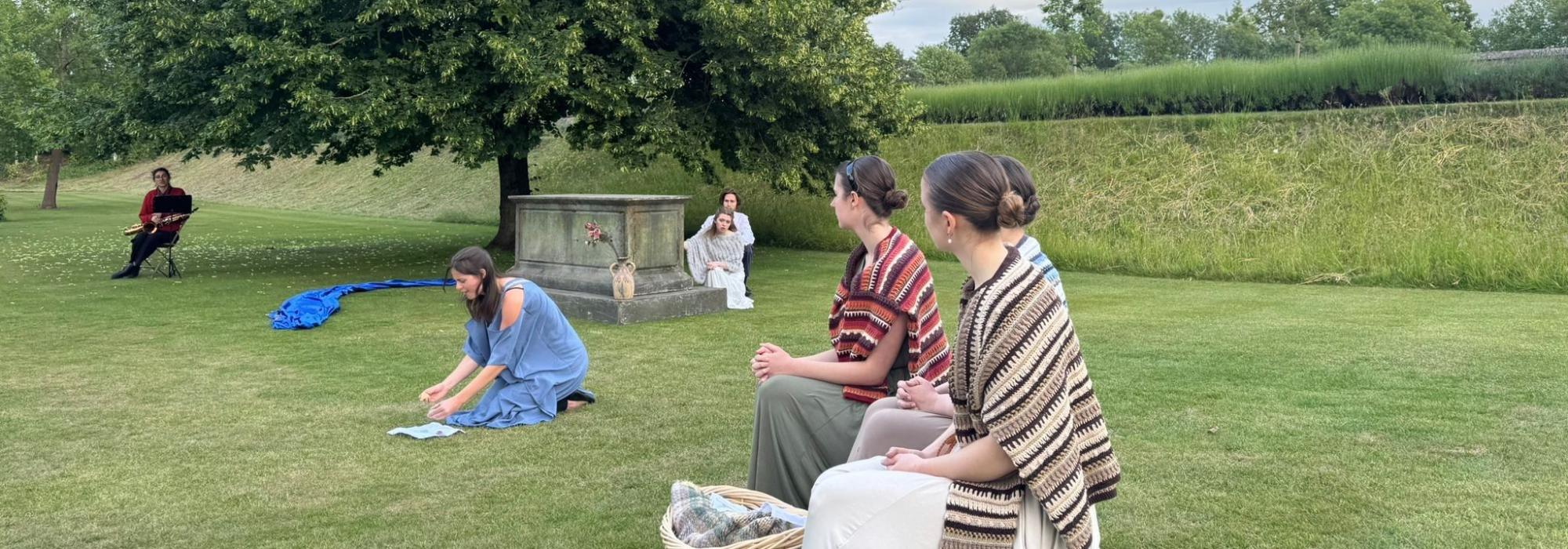 Merton Floats Garden Play 2025: Helen Students in costume in a garden performing in a play