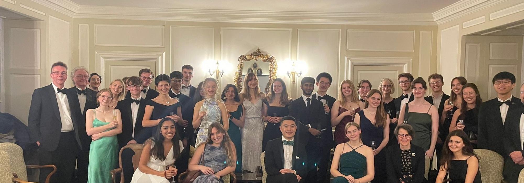 people in evening dress seated for a group photo 
