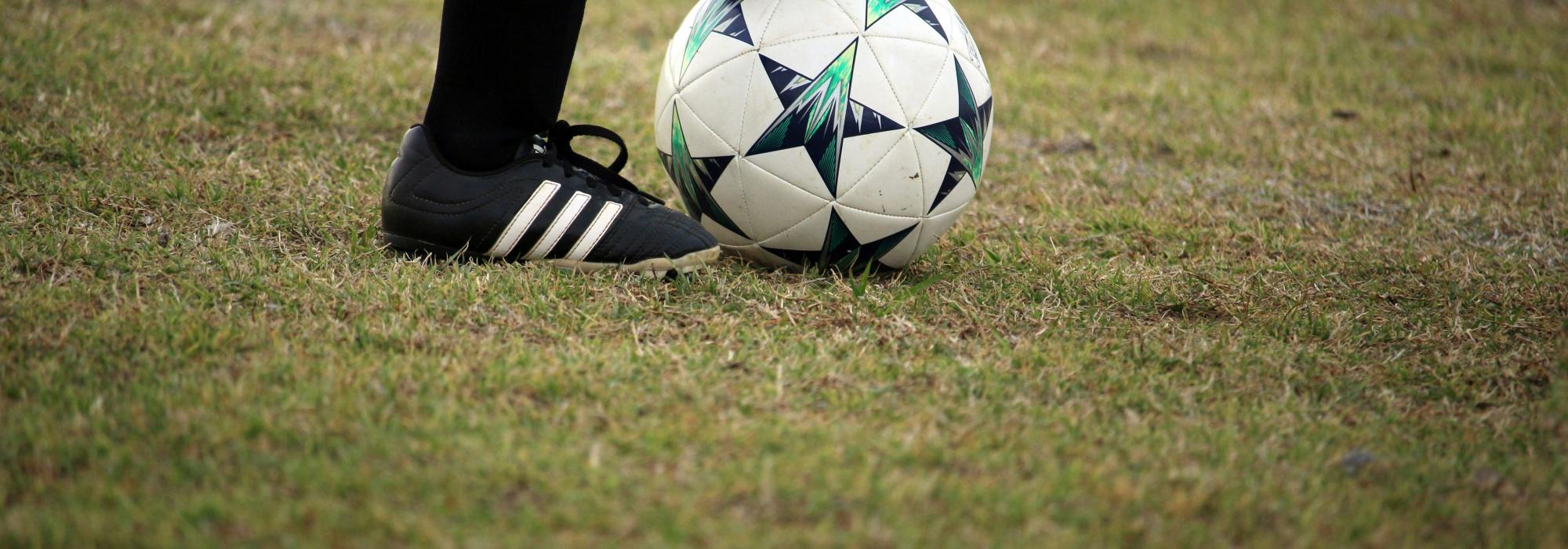 Men's football. Photo: Hal Gatewood on Unsplash footballer's boot on a ball