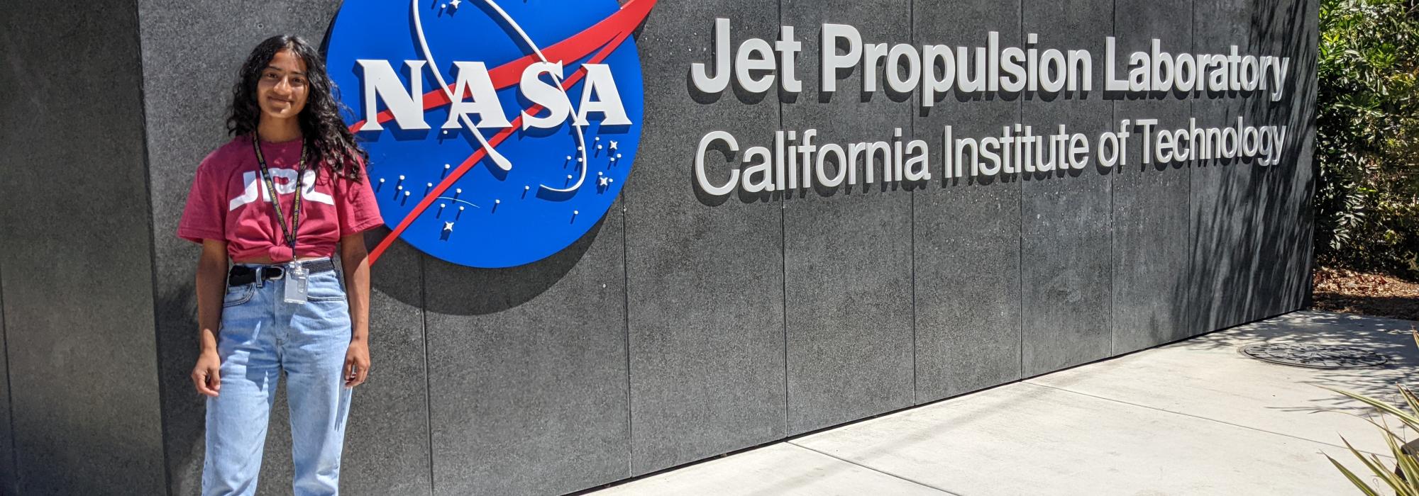Khadija Sarguroh stood in fron of the NASA sign