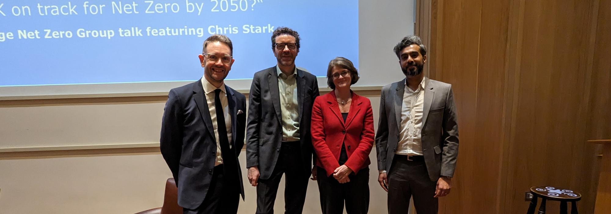 four people standing for a photo at a talk