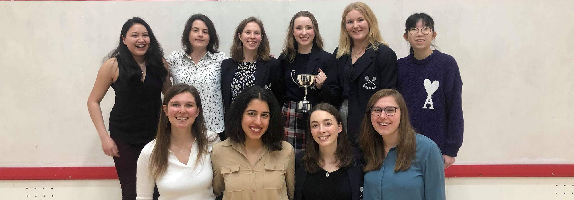 Catherine Felce (2016) front row, far right, and Laura Neill (2018), holding the trophy as captain, at the Blues Varsity at the RAC in London. The women’s team beat Cambridge 4-1, as did the men. Photo: Anna Willis Catherine Felce (2016) front row, far right, and Laura Neill (2018), holding the trophy as captain, at the Blues Varsity at the RAC in London. The women’s team beat Cambridge 4-1, as did the men. Photo: Anna Willis