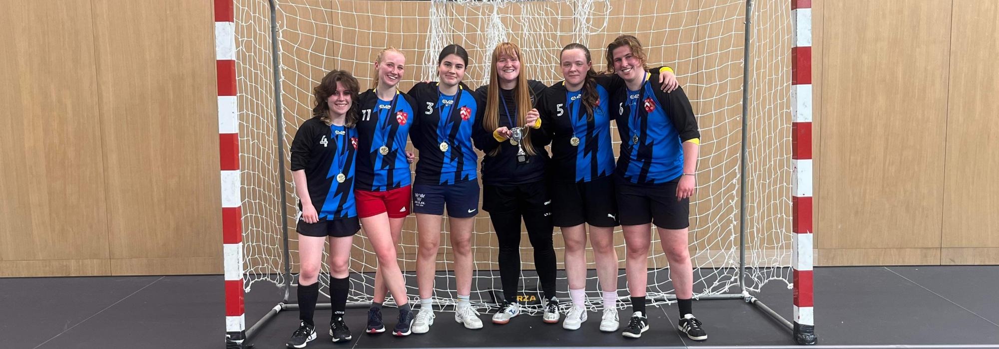 'Wertonfield' football and futsal players 2023/24 Merton women footballers gathered in a goal