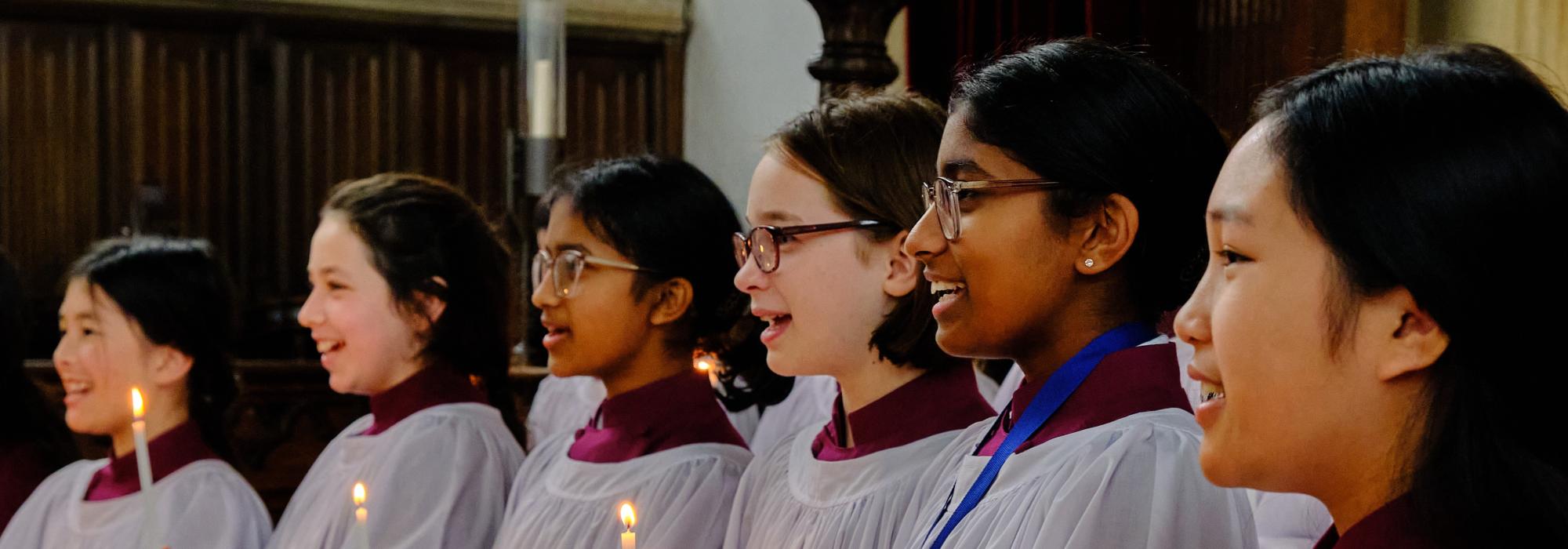 Girl Choristers lit by handheld candles