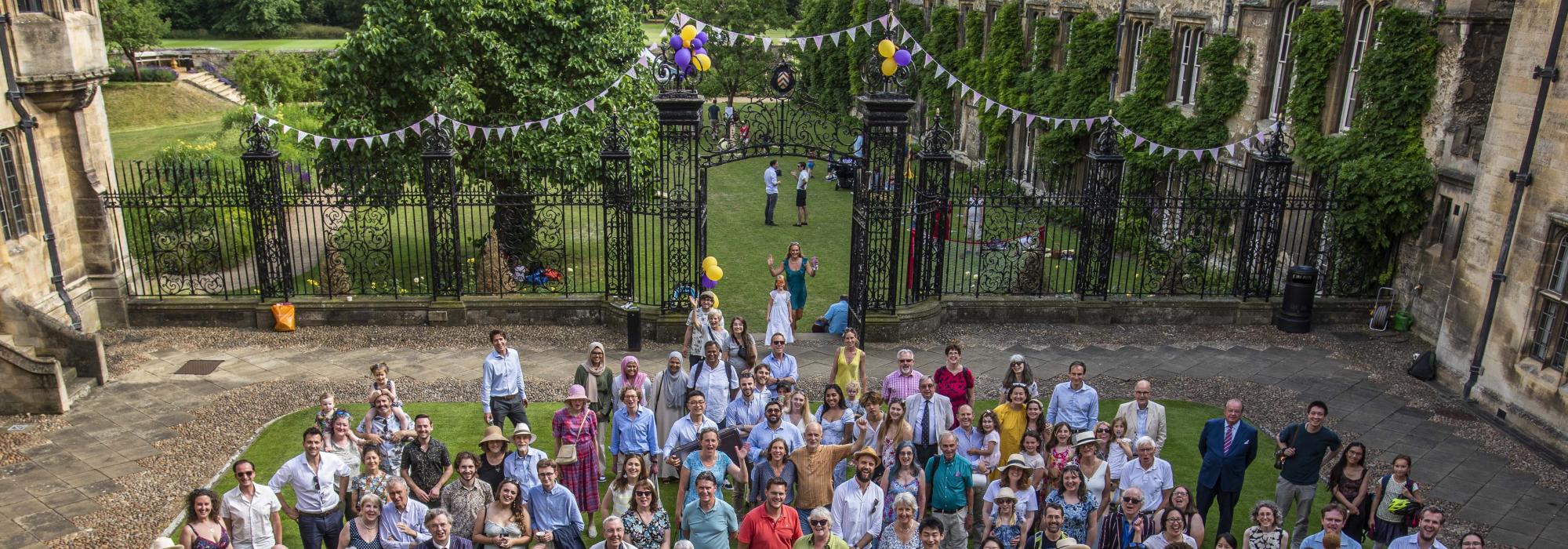 Merton Society Garden Party 2022 (c) John Cairns A large group of people standing on the lawn looking up at the camera
