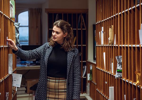 A student checking their pigeonhole for post, 2019 - Photo: © John Cairns - www.johncairns.co.uk