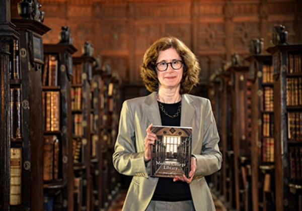 Dr Julia Walworth with a copy of her book, a history of Merton College Library, in the Upper Library - Photo: © Ian Wallman - www.ianwallman.com