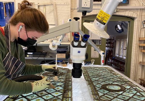 A conservator at York Glaziers Trust working on the Upper Library's medieval stained glass