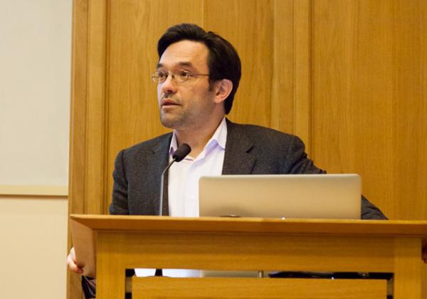 Professor Alex Schekochihin at the lectern in the TS Eliot Lecture Theatre, Merton College