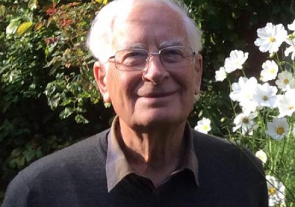 portrait of a formally dressed man in a garden setting