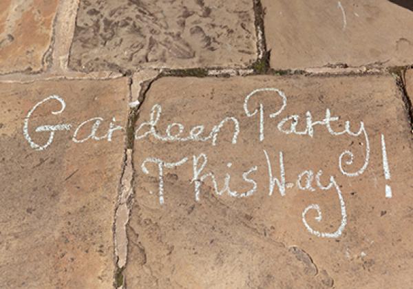 Garden Party This Way! chalked on a flagstone