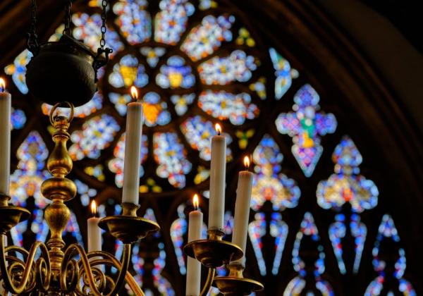 Chapel Chandelier against the blue purple stained glass