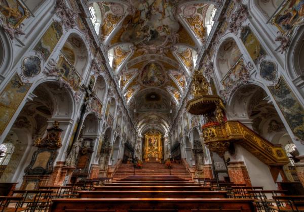 Interior of a cathedral with painted ceiling and gold accents