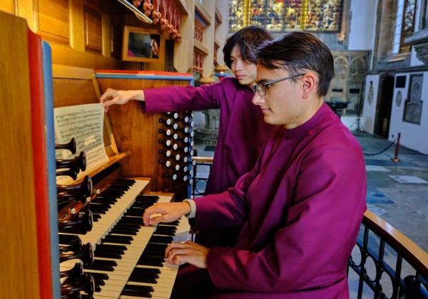 Francois Cloete wearing a maroon cassock at the Dobson Organ