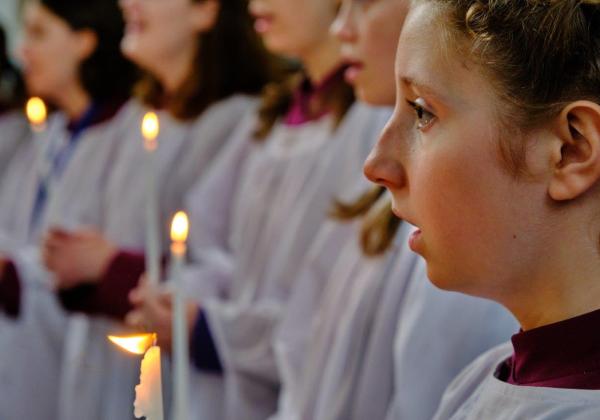Girl Choristers lit by handheld candles