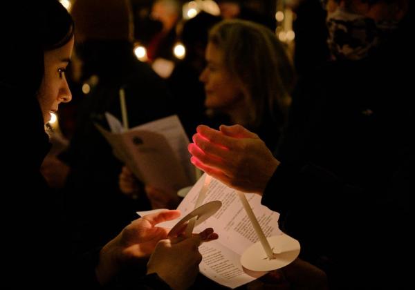 A candle being lit in Chapel