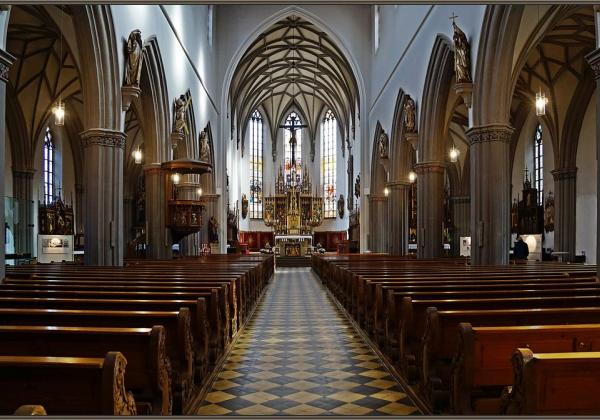 Interior of a church with dark wood pews and white painted walls