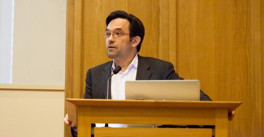 Professor Alex Schekochihin at the lectern in the TS Eliot Lecture Theatre, Merton College