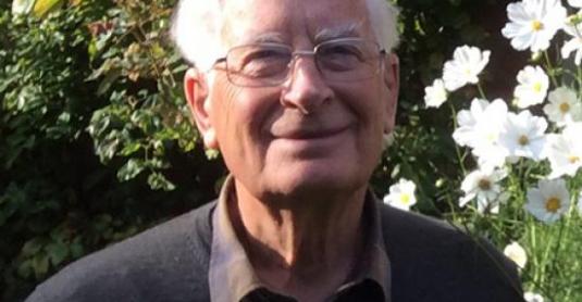 portrait of a formally dressed man in a garden setting
