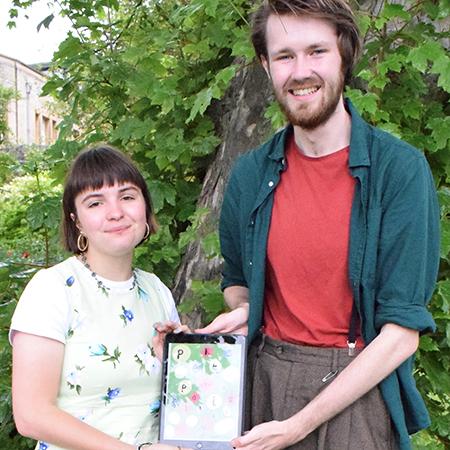 Rachel Jung and Luke Bateman holding up the Society’s pamphlet 'Pekes and Pollicles'