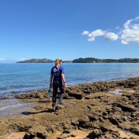 Student walking on beach