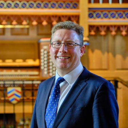 Benjamin Nicholas, Director of Music, in front of the Dobson Organ