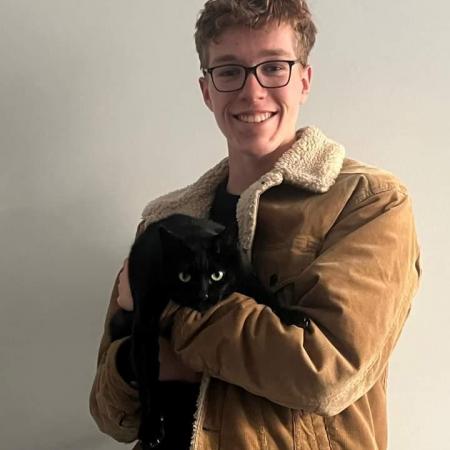 Harry Colegate young man holding a cat