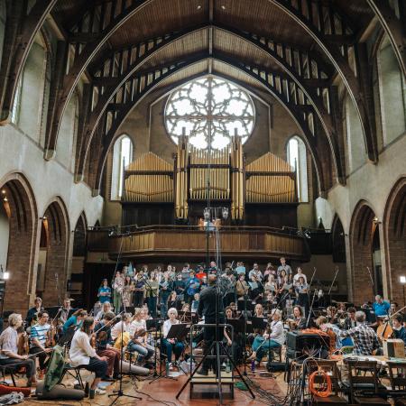 Orchestral Anthems II Choir and full orchestra surrounded by microphones and lit by a large church window